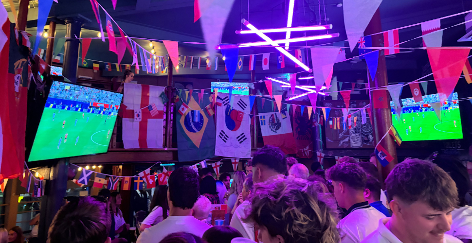Football fans watching big screens on the barbican in Plymouth